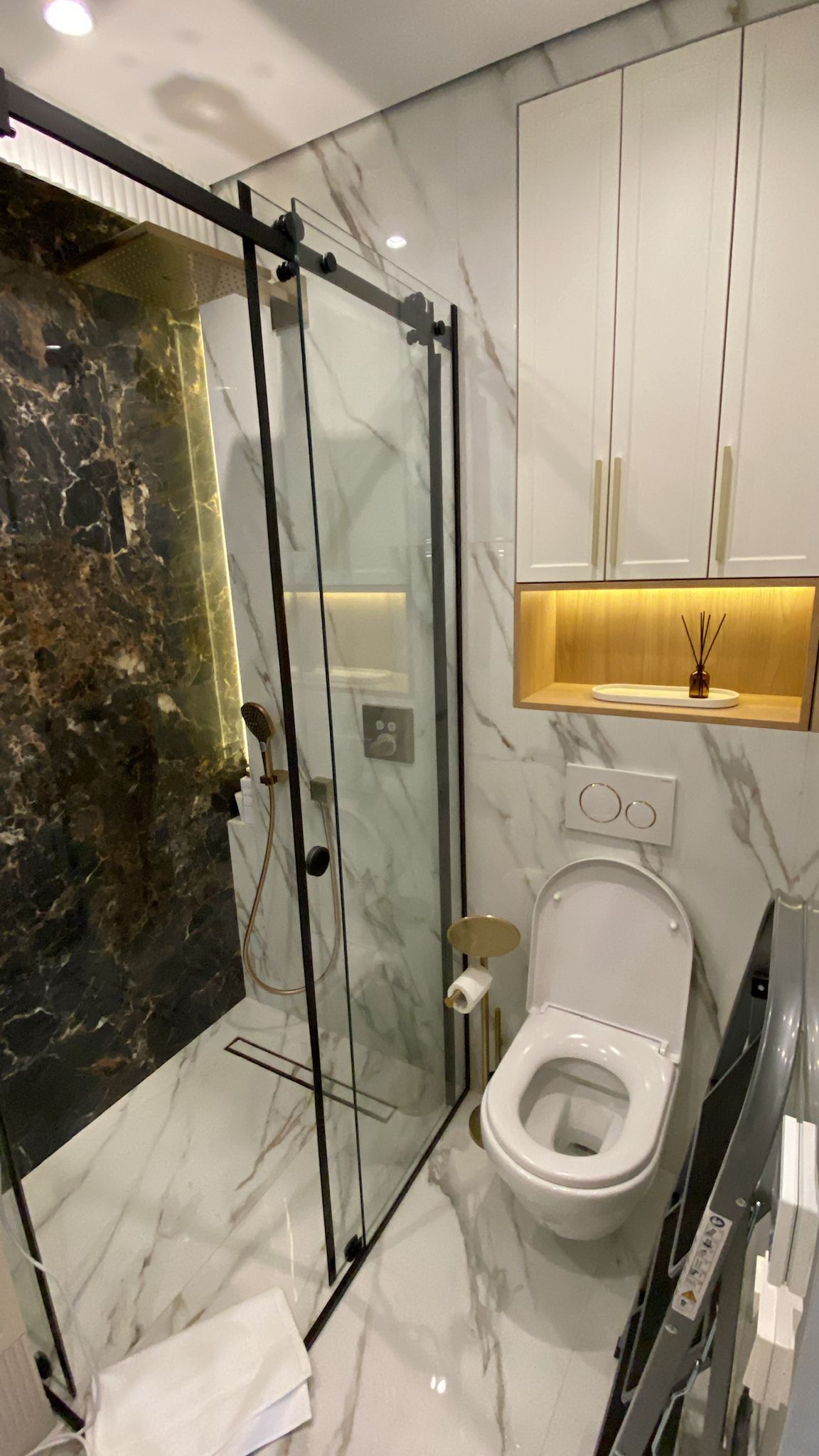 Marble shower with glass enclosure